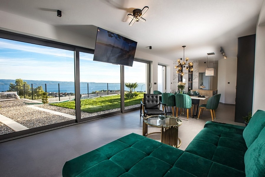 Modern living area with large glass fronts and sea views