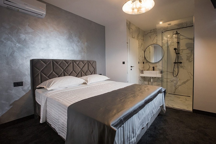 Bedroom with double bed and open bathroom en-suite