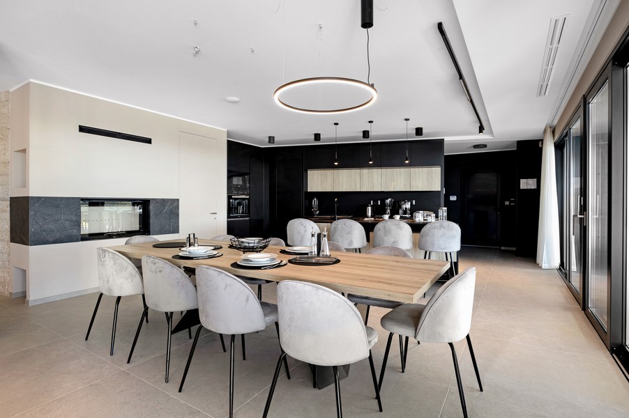 Dining area with designer kitchen and modern lighting