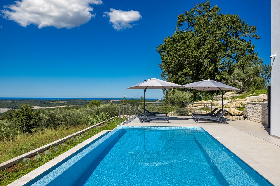 Spacious pool area with sun terrace and sea views