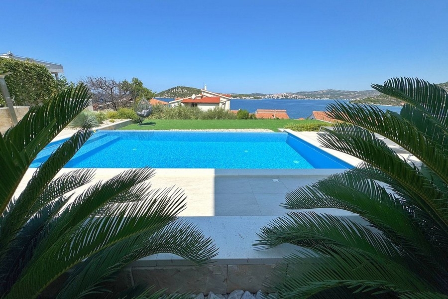 Swimming pool with sun terrace and bay views