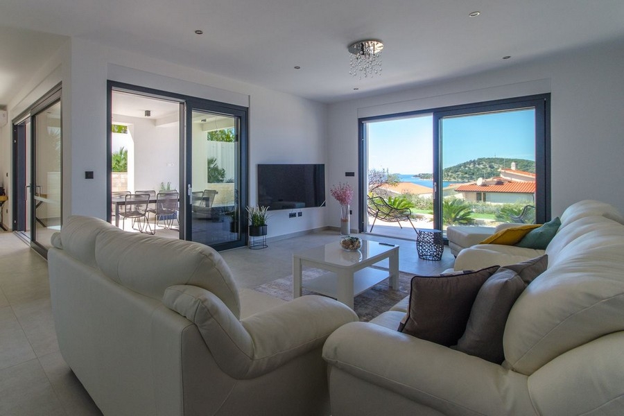 Bright living area with large glass front and sea views