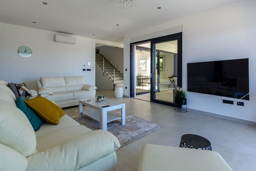 Open living room with TV area and access to the terrace