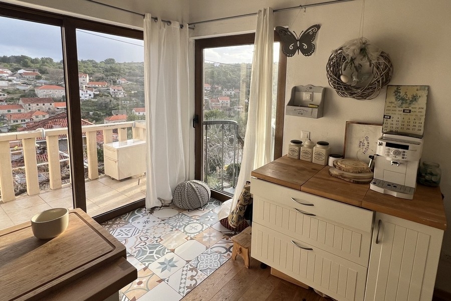 Kitchen area with floor-to-ceiling windows and access to the balcony