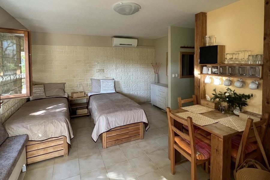 Bedroom with two single beds and small dining area