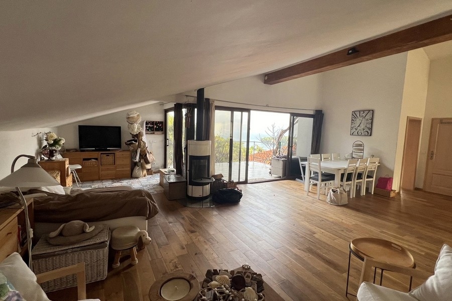 Open living and dining area with fireplace and panoramic windows
