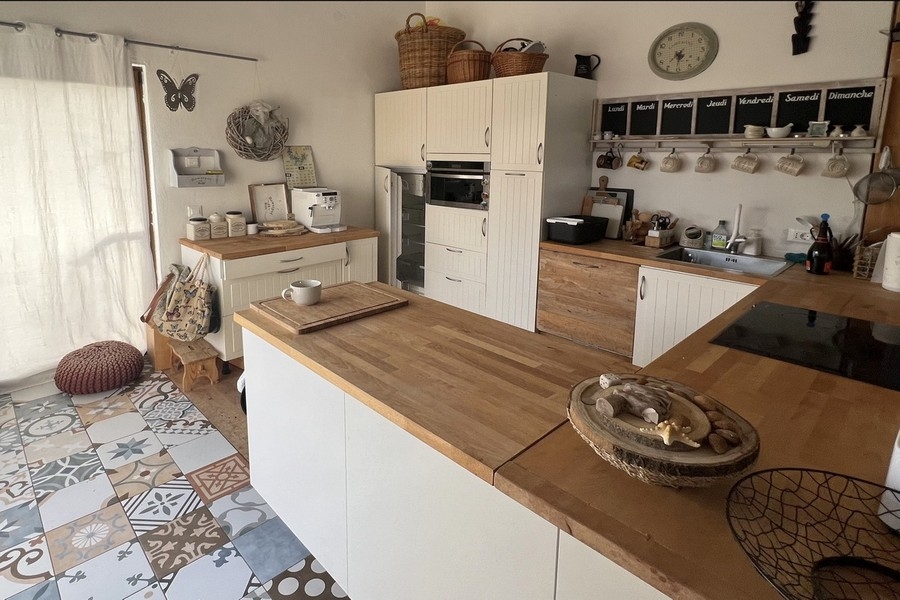 Modern kitchen with cooking island and wooden worktop