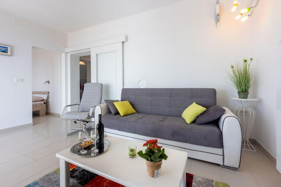 Living area with sofa and open access to the bedroom