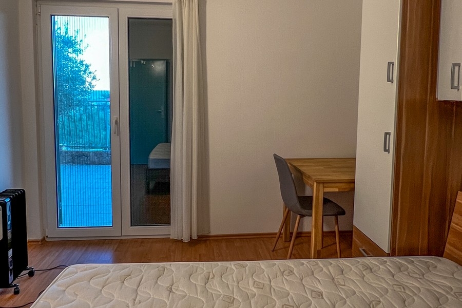 Bedroom with balcony access and desk