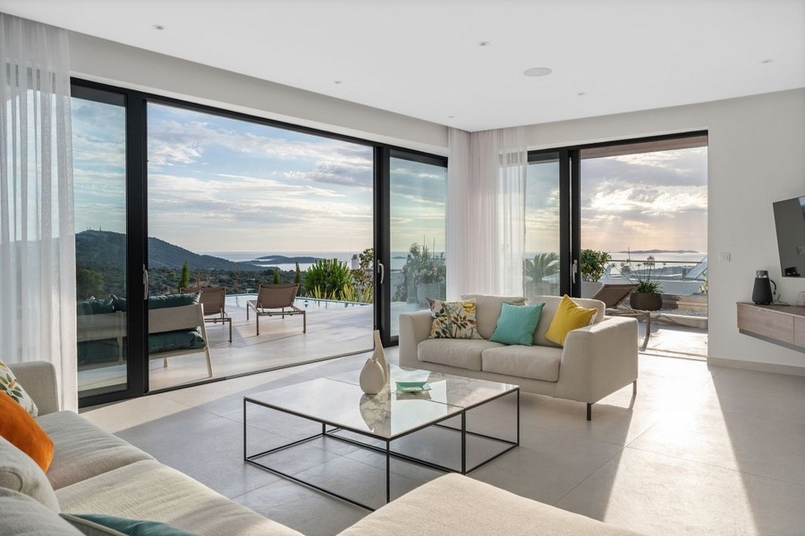 Living room with access to the terrace and views of the coastal landscape