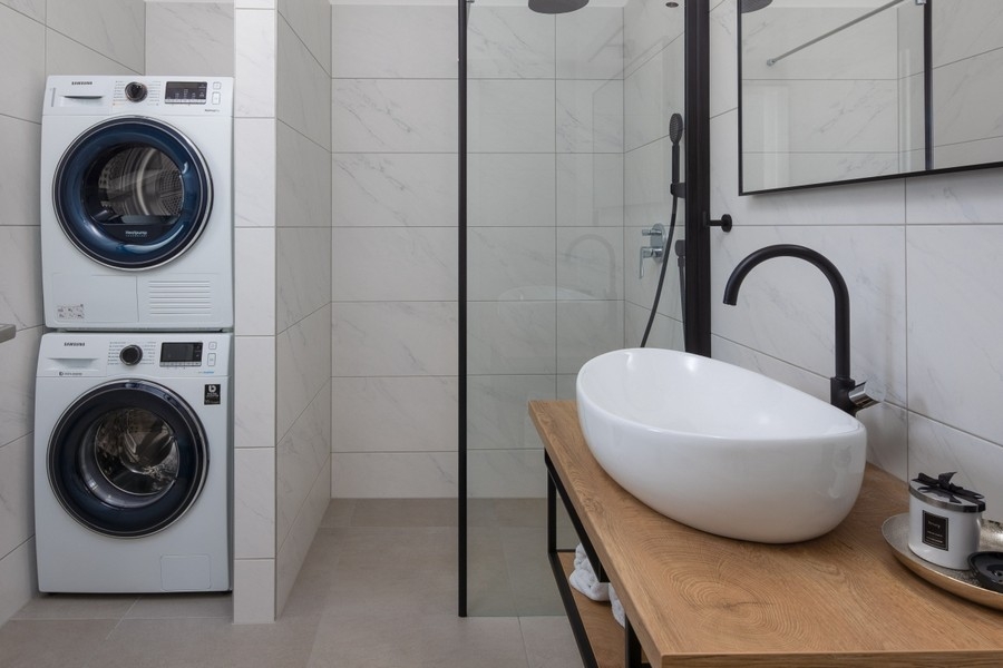Modern bathroom with shower and washing machine