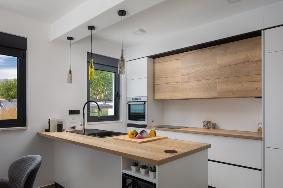 Modern kitchen with cooking island in villa near Split