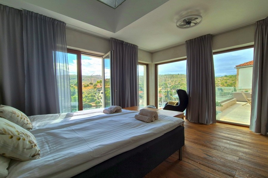 Bedroom with panoramic windows and sea views