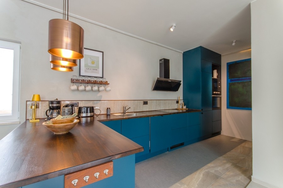 Modern kitchen with cooking island and wooden worktop