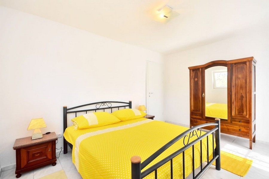 Bedroom with yellow bed and wardrobe