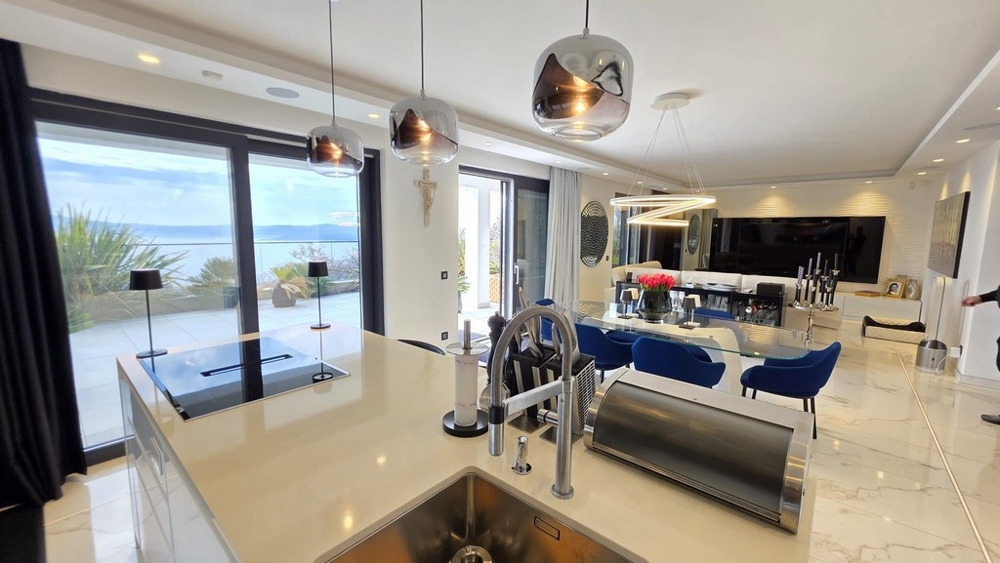 Open plan living area with kitchen and sea views