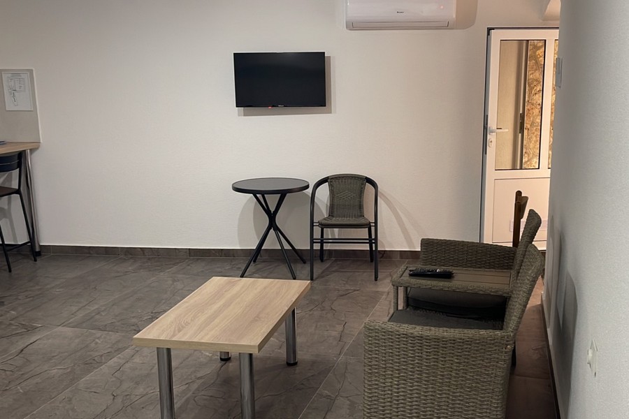 Living area with armchair and TV in the apartment in Croatia