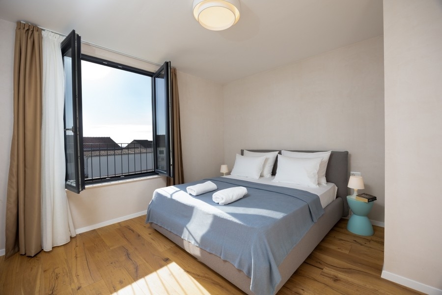 Bedroom with double bed and open window