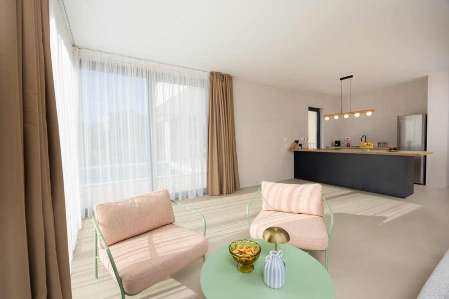 Open living area with kitchen and large windows