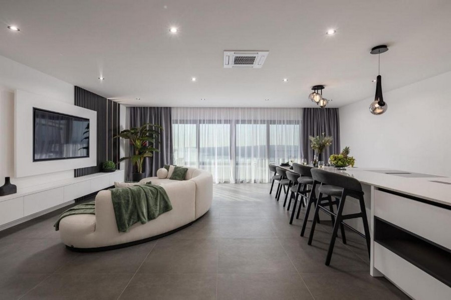 Open living room with kitchen and large window front