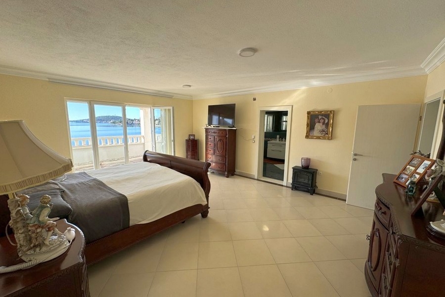 Bedroom with large bed and direct sea views