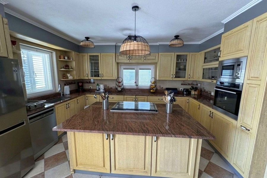 Open kitchen with dining area and access to the terrace with sea views