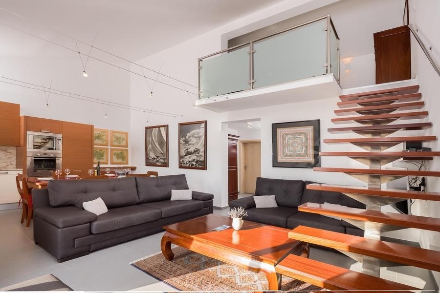 Open living area with kitchen and gallery