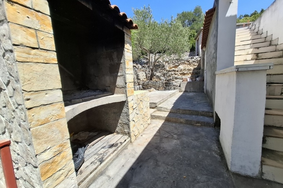 Outdoor area with stone barbecue and stairs in the garden