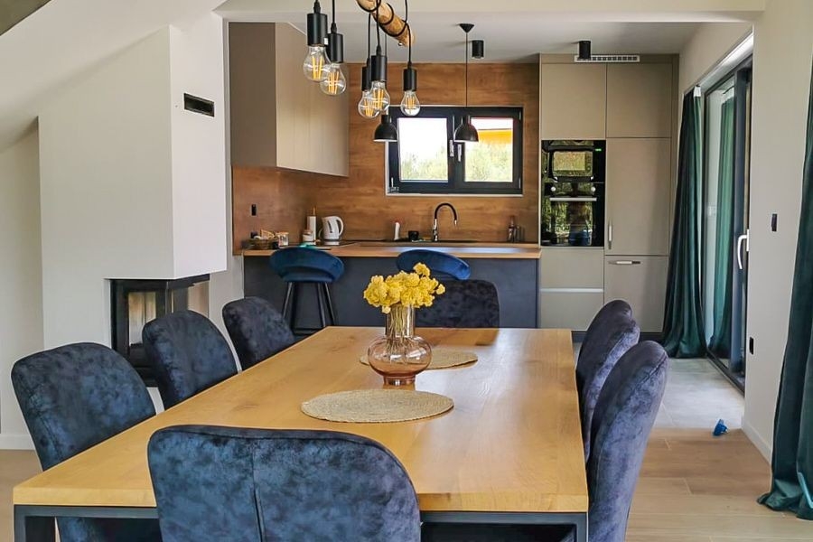 Open living area with kitchen and fireplace in modern villa