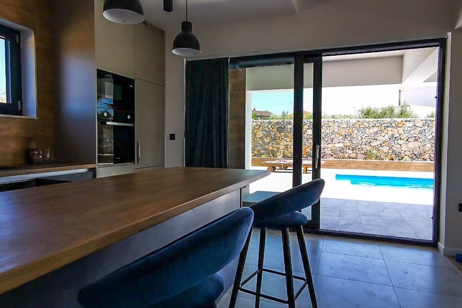 Kitchen overlooking terrace and swimming pool