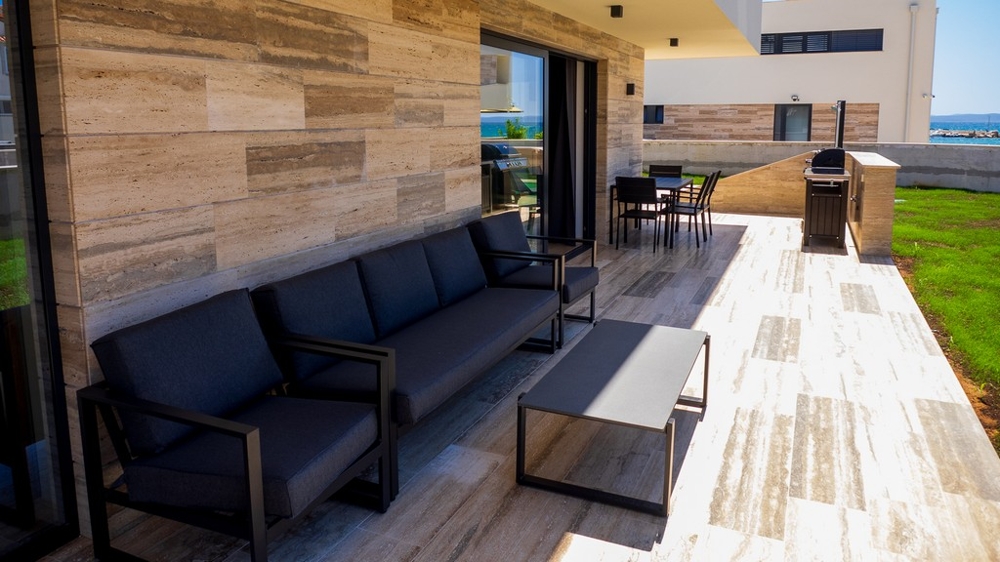 Covered terrace with lounge and barbecue area