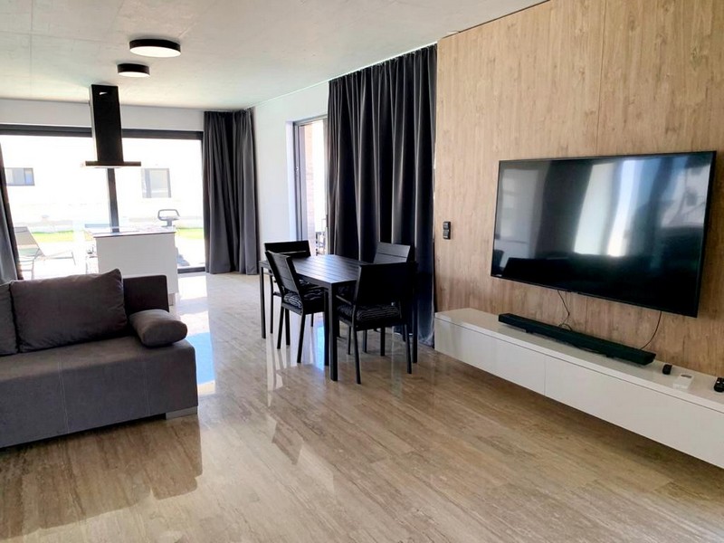Modern living area with sofa and TV of the villa in Privlaka