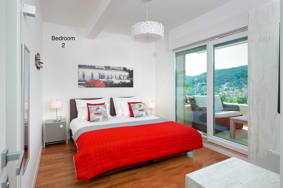 Bedroom with double bed and balcony with sea views