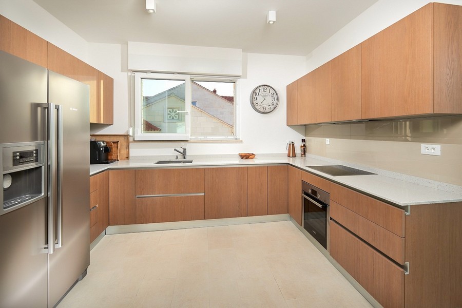 Modern kitchen with built-in appliances and work surfaces