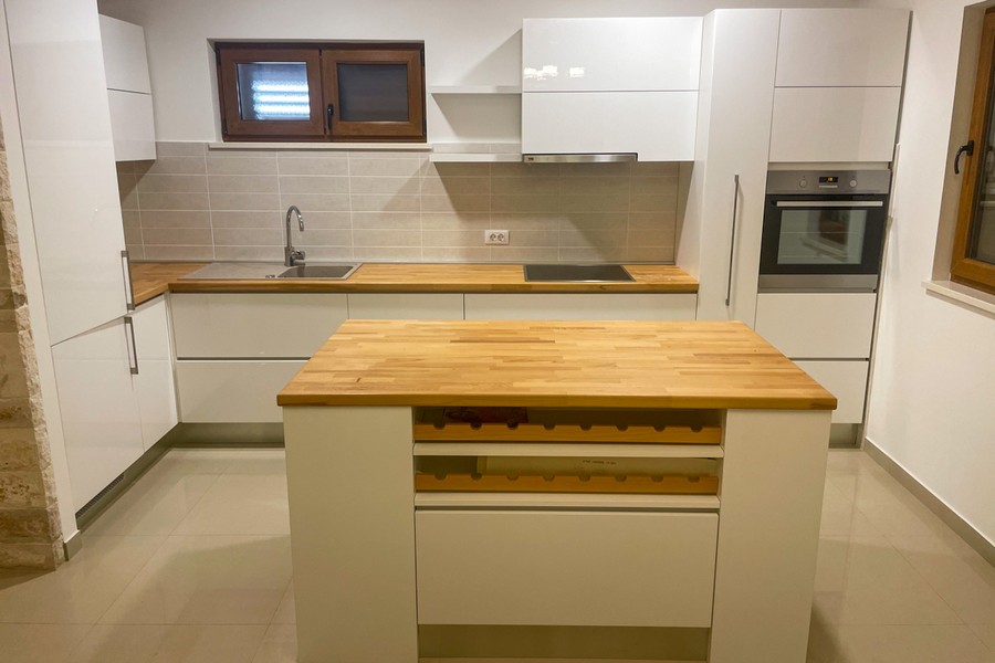 Modern kitchen with cooking island and built-in appliances