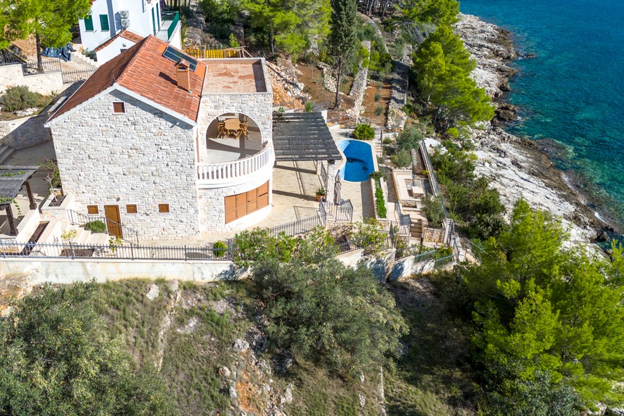 Covered terrace with pergola and natural stone facade