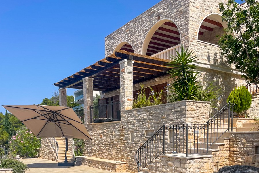 Mediterranean stone villa with balcony and terrace in the first row to the sea