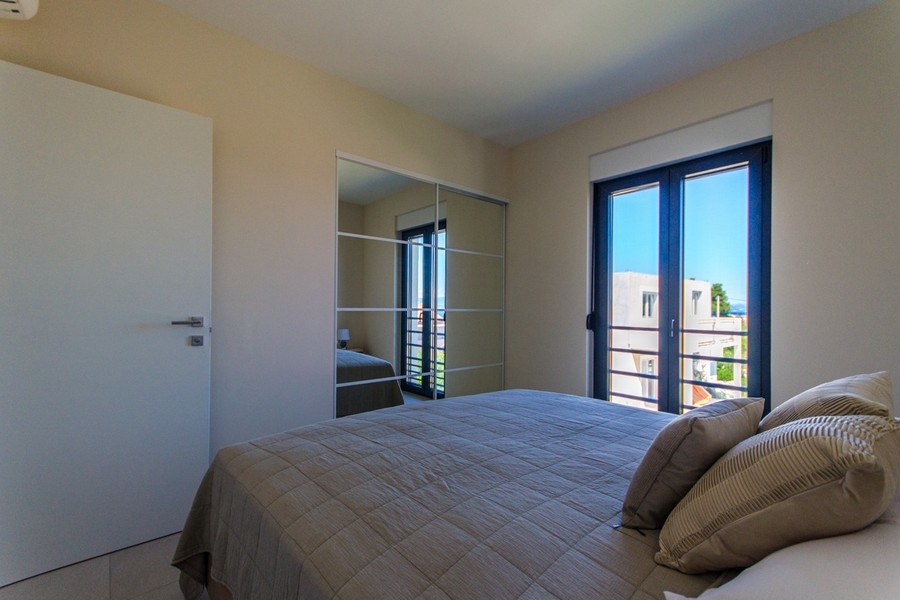Bedroom with built-in wardrobe and balcony access
