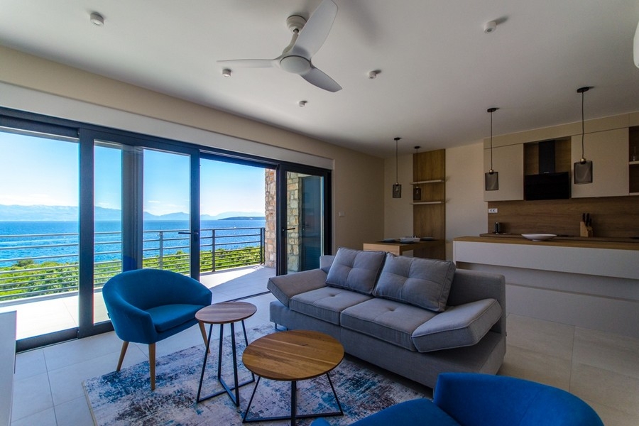 Living room with sea view and large window front in a modern apartment