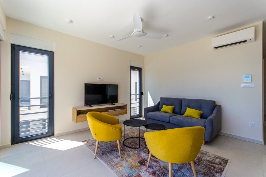 Modern living room with air conditioning and large windows with sea views