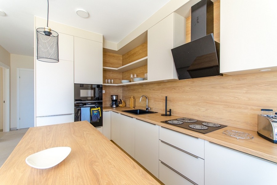 Modern kitchen with built-in appliances and wooden worktop