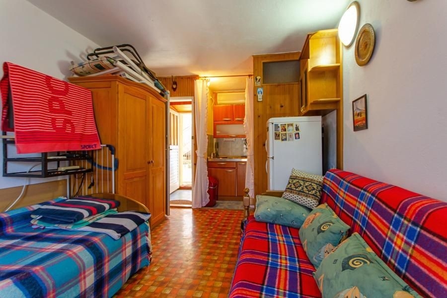 Living room with sofa and small kitchen