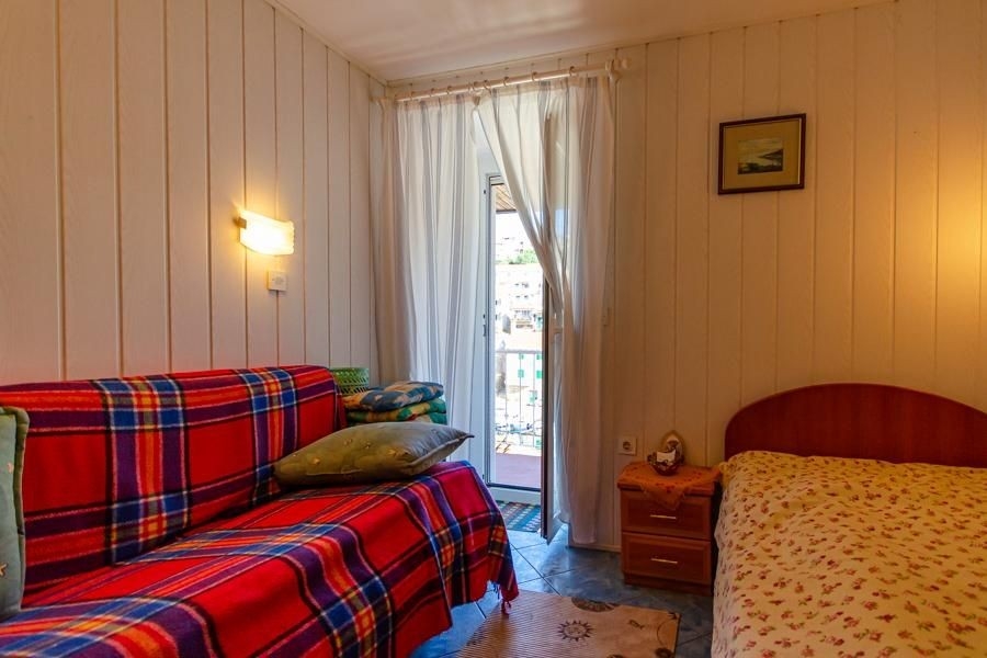 Room with balcony access and sleeping area