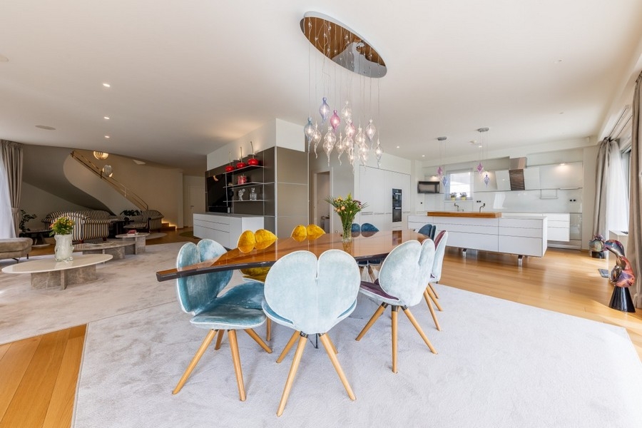 Open dining area with designer lighting and modern kitchen
