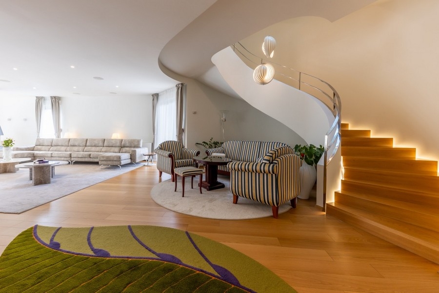 Elegant living room with seating area and curved staircase