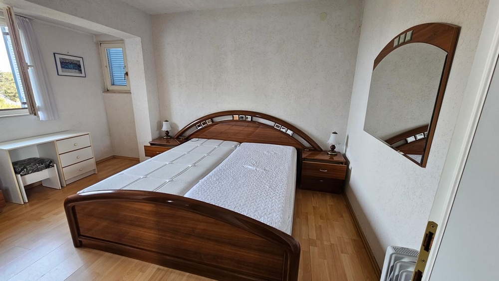Bedroom with wooden bed and mirror