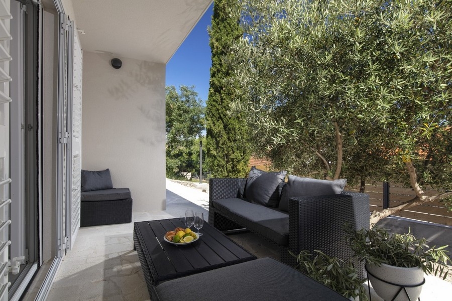 Covered terrace with seating and garden views