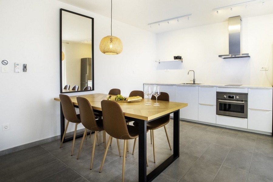 Open kitchen with dining table and modern fitted kitchen