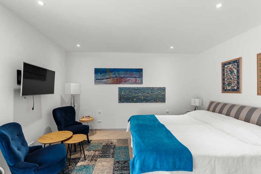 Bedroom with large double bed and seating area