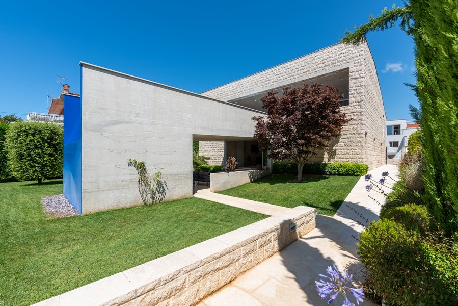 Modern villa with garden and architecture made of natural stone